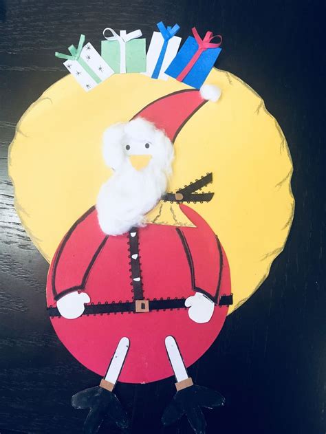 A Paper Plate With A Santa Clause On Its Face And Scissors In The