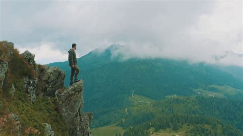 the man standing on cliff of rock stock footage sbv 337741100 storyblocks
