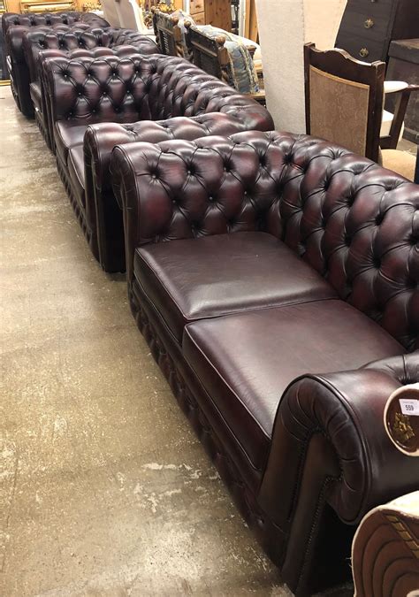 A Thomas Lloyd Four Piece Oxblood Chesterfield Suite Comprising A Pair