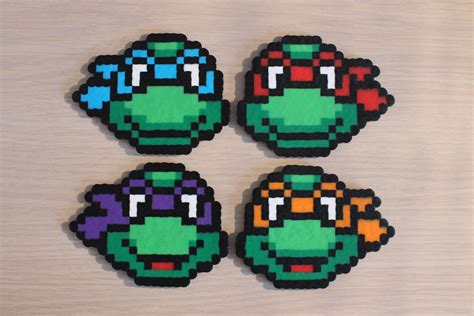 Four Pieces Of Pixel Art Made To Look Like Teenage Mutant Turtles