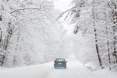 Car Driving After Heavy Snowfall Transportation In Winter Road