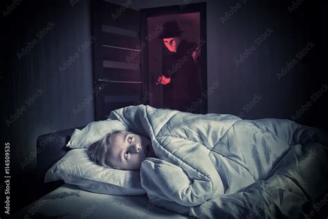 Nightmare Scared Boy Lying In The Bed While The Masked Stranger