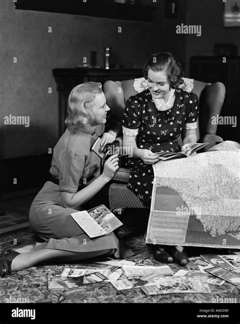 1930s 1940s Two Women Reading Maps And Travel Brochures Smiling Planning Vacation Travel Chair