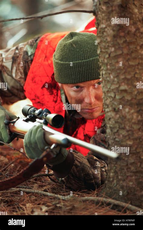 Deer Hunter Stalking With Rifle Stock Photo Alamy