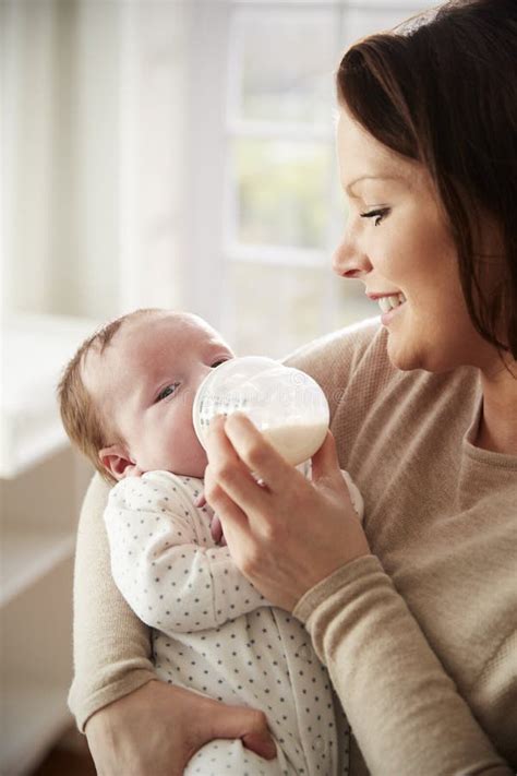 Mother Feeding Newborn Baby From Bottle At Home Stock Image Image Of