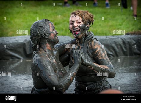 Two Women Mud Wrestling At A Mud Fighting Competition At The LowLand