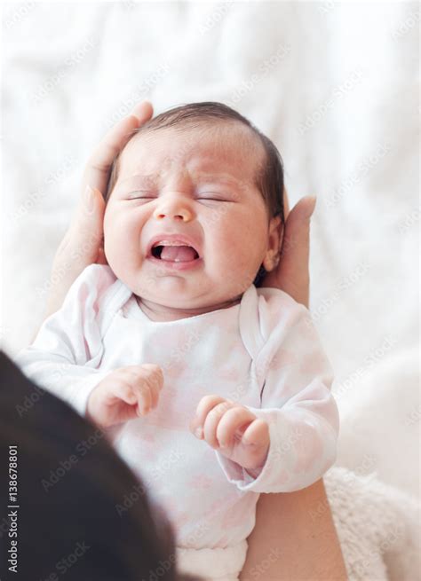 Newborn Baby Crying In The Arms Of Her Mother Stock Photo Adobe Stock