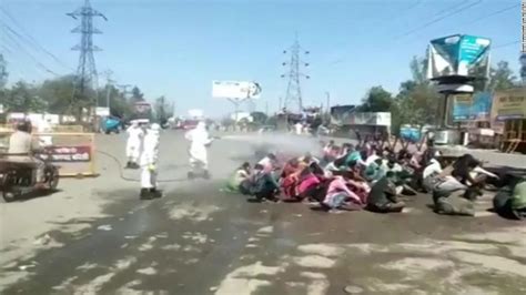 India Coronavirus Migrant Workers Sprayed With Disinfectant In Uttar