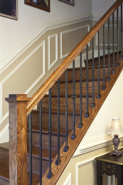 A Wooden Stair Case With Metal Handrails In A Homes Entryway