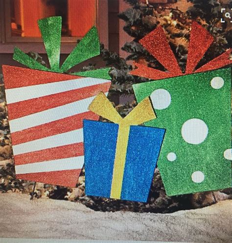 Wooden presents on stakes for outside | Outdoor christmas presents, Christmas decorations diy 