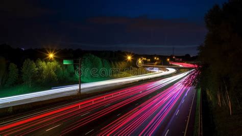 Speed Traffic Light Trails On Motorway Highway At Night Stock Photo