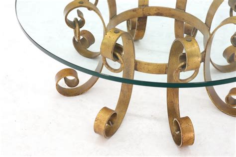 The top material of the table is a round glass top with a brown rust finish, fitted directly onto the metal base. Round Decorative Gilt Wrought Iron Base Glass Top Sunburst ...