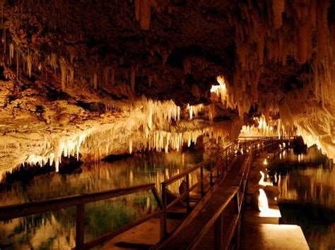 Visitors To Bermudas Crystal Cave Walk On Floating Pontoons As They