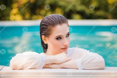 Portrait Of A Beautiful Girl With Wet Hair Dressed In A White Shirt