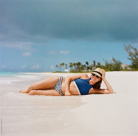 Beautiful Woman In A Bikini Laying On A Beach Del Colaborador De Stocksy Jakob Lagerstedt