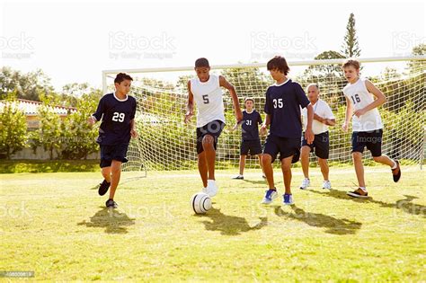 Members Of Male High School Soccer Playing Match Stock Photo Download