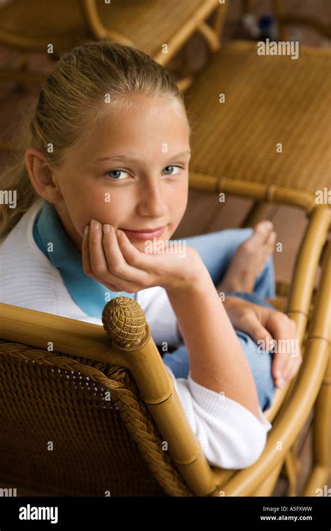 Portrait Of Caucasian Pre Teen Girl With Chin In Hand Looking At Viewer