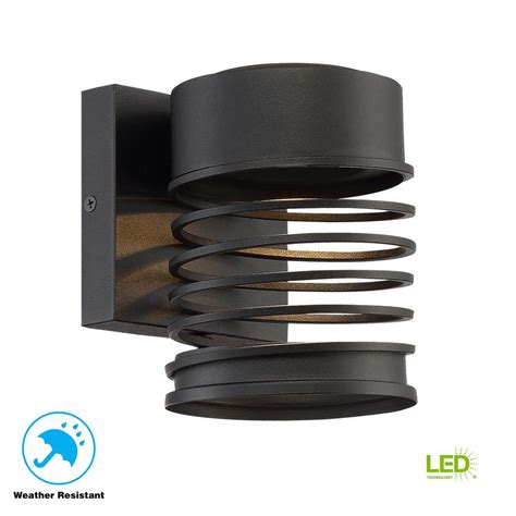 This outdoor wall light will cast an appealing glow for a front porch or outside entryway. Home Decorators Collection Masena 1-Light Sand Black Outdoor Integrated LED Wall Mount Lantern ...