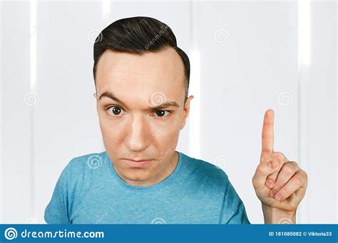 Young Frowns Threaten Man Point Finger, Dressed In A Blue T Shirt Stock ...