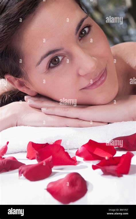 Portrait Of A Woman Lying On A Massage Table With Rose Petals Stock