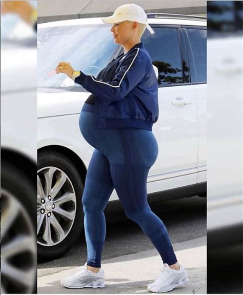 heavily pregnant amber rose showcases her huge bump in new photo