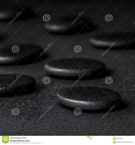 Spa Concept Of Zen Stones On Black Background With Dew Stock Photo