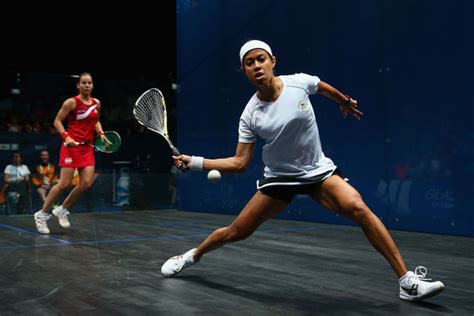Two Women Playing Tennis On An Indoor Court