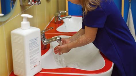 Child Washing Hands With Soap In Bathroom In Kindergarten Protection