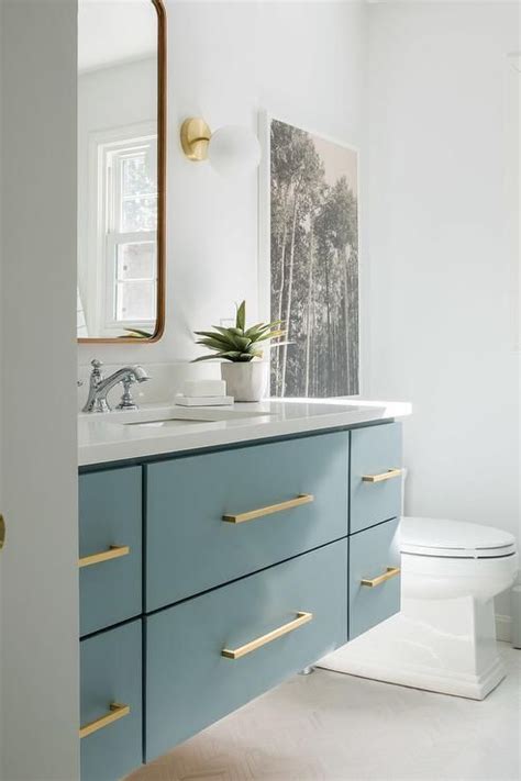 Limited time sale easy return. Blue floating sink vanity with gold pulls featuring a gold ...