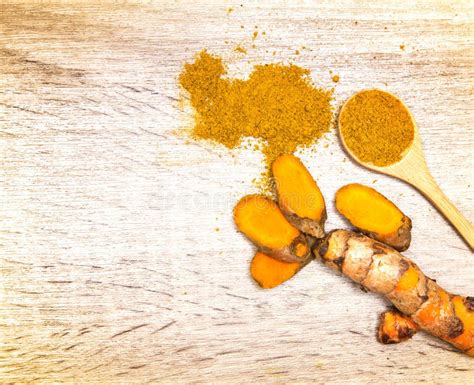 Turmeric Powder In Spoon And Roots On Wooden Plate Stock Image Image