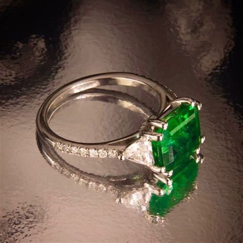 Take A Look To This Gorgeous Emerald Engagement Ring Flanked By Diamond