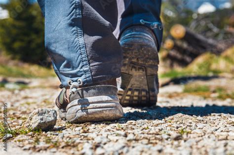 Hiker Walking On Path In The Mountains Close Up Of Shoes Stock Photo