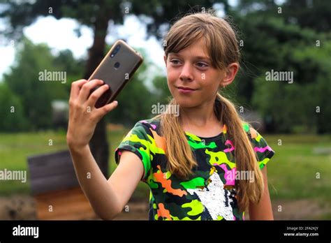 Selfie A Ten Year Old Girl Poses And Takes A Selfie By Hand Beautiful Teenage Girl Takes