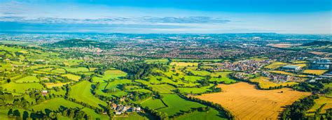 Aerial Panorama Over Green Farmland Pasture Golden Crops Country Town
