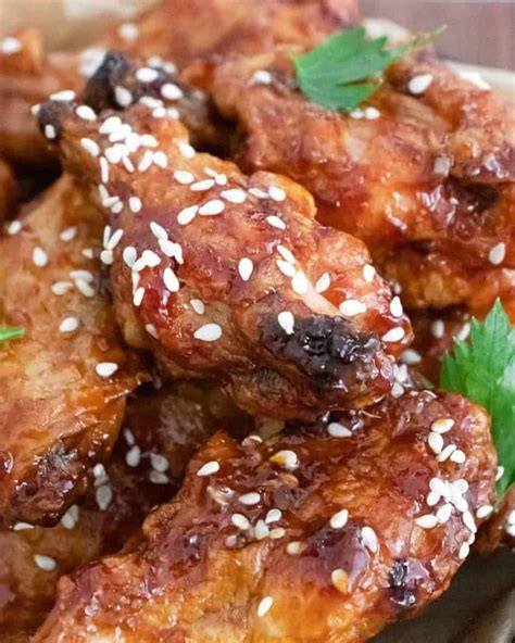 sticky and spicy crispy baked asian chicken wings are easy to make and fun to eat toss the