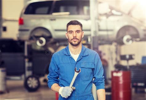 Auto Mechanic Or Smith With Wrench At Car Workshop Stock Photo Image