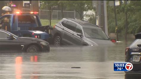 Downpours And Gusty Winds Damage Homes Flood Roads Stall Cars Across
