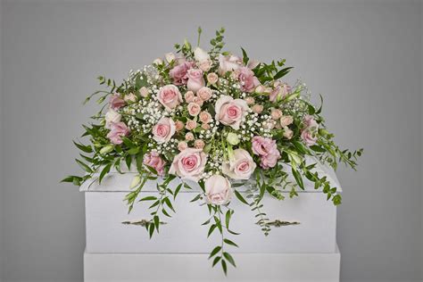 Where our designs include a sundry item like a vase or basket it may not always be possible to include the exact item as displayed. Baby Girl Casket Spray - Ramsgate Floral Designs