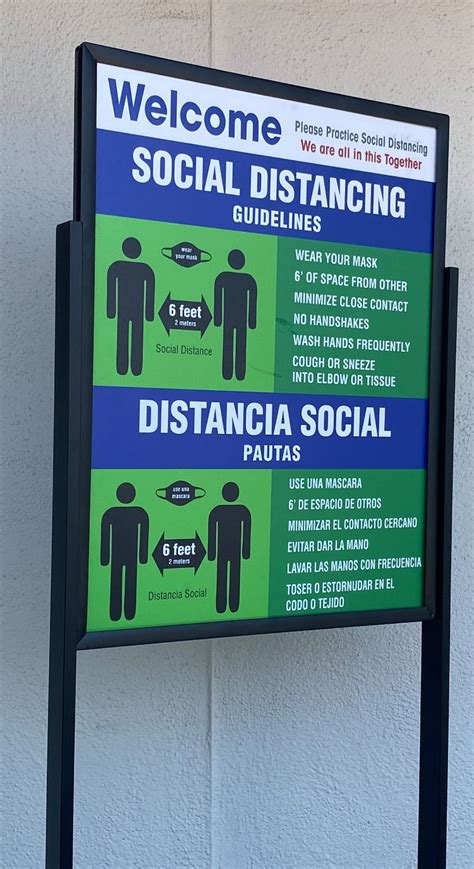 Bilingual Welcome Sign With Social Distancing Guidelines