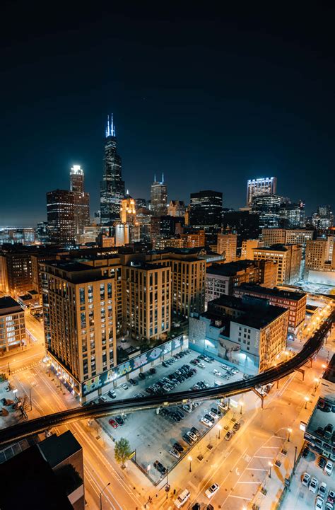 Download Experience The Bustling City Of Chicago By Night Wallpaper