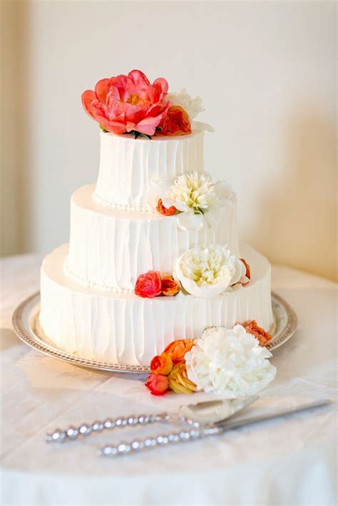 Buttercream Wedding Cake With Coral And White Flowers