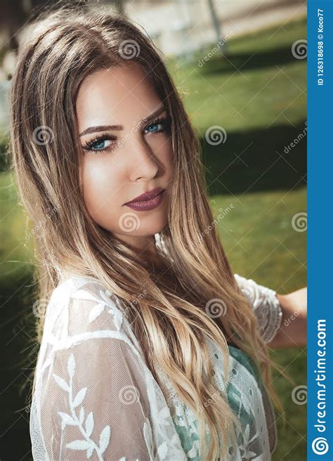 Portrait Of A Young And Beautiful Blonde Woman Blue Eyes Long Hair