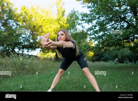 Fitness Model Goes In For Sports In The Park Outdoors Doing Forward