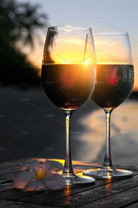 Romantic Beach Scene Two Glasses Of Red Wine At Sunset Near Water