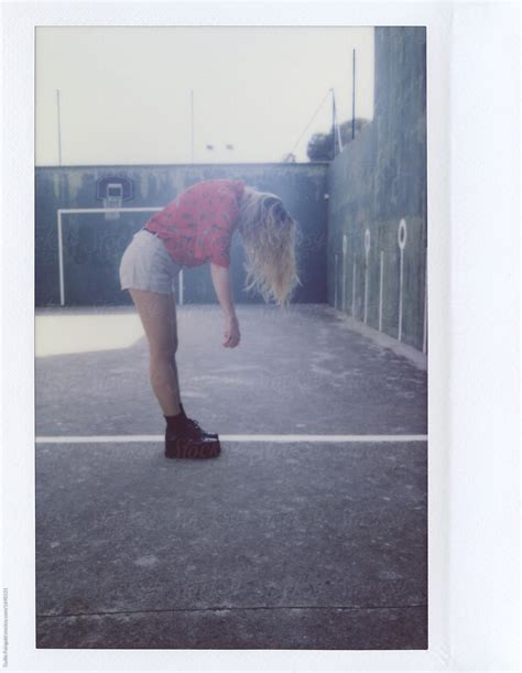 View Blonde Girl In Shorts Bowing Down By Stocksy Contributor