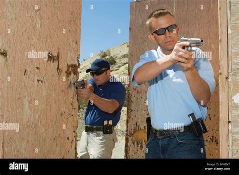 Two Men Aiming Hand Guns At Firing Range Stock Photo Alamy
