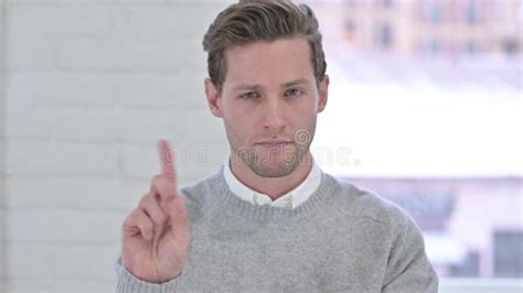 Portrait Of Creative Young Man Saying No With Finger Sign Stock Image