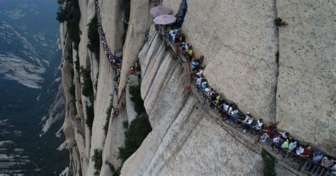 Tourists Take On Death Defying Walk Along One Of The Worlds Most
