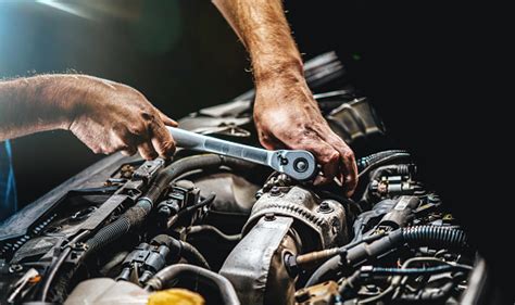 Auto Mechanic Working On Car Engine In Mechanics Garage Repair Service