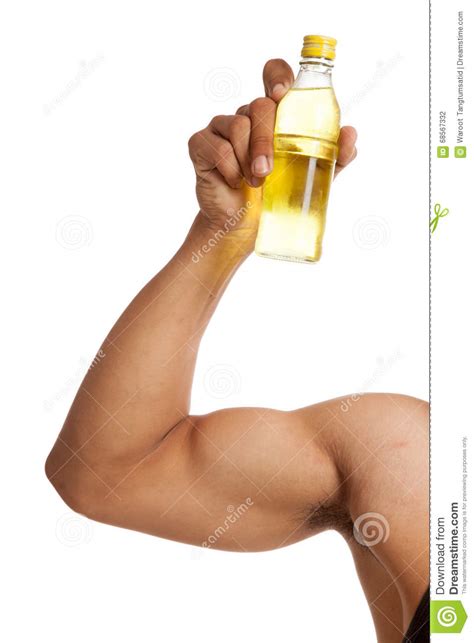 Muscular Asian Mans Arm Flexing Biceps With Electrolyte Drink Stock